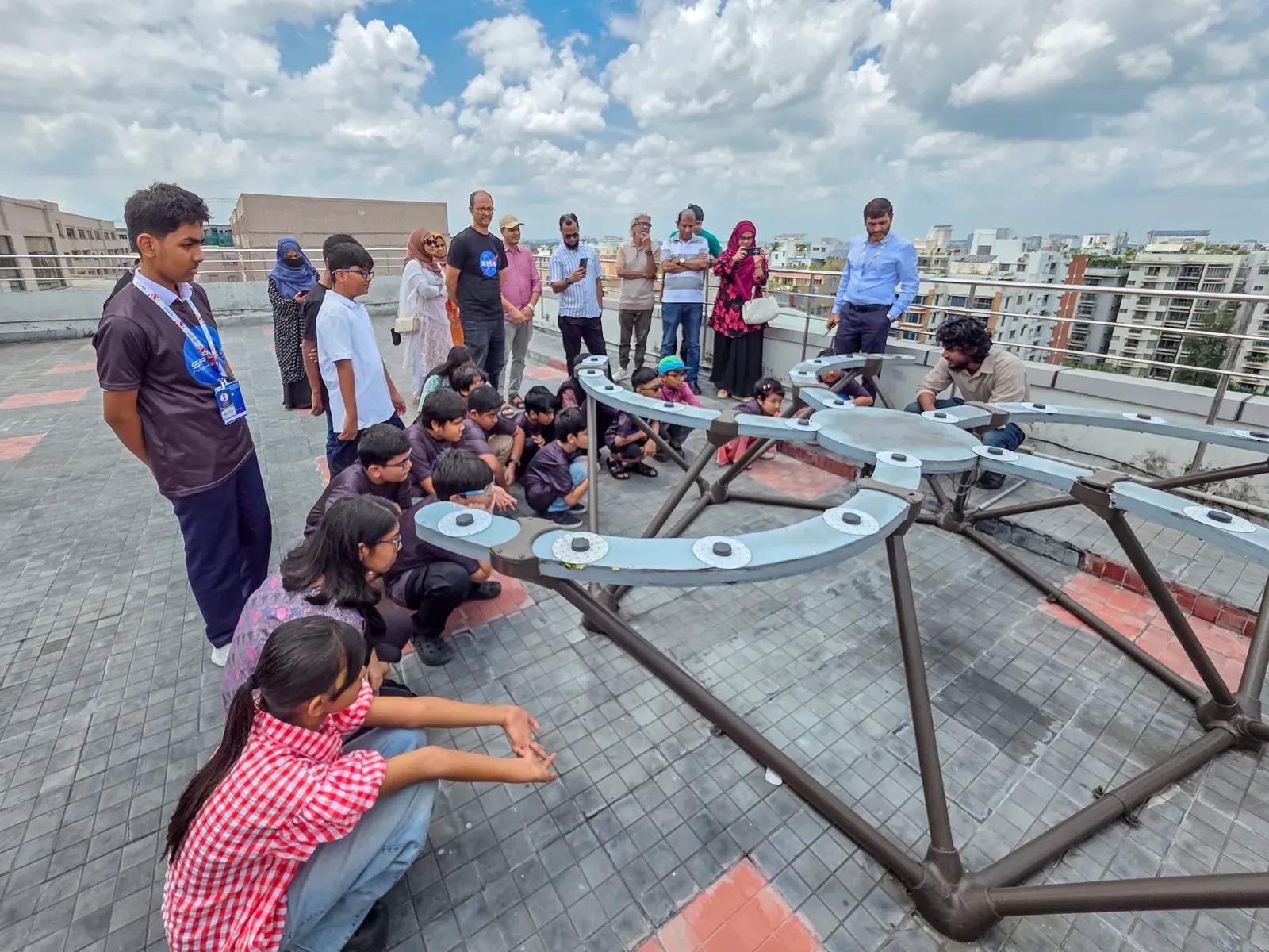 Students from Space Innovation Camp gather around CASSA's TART radio telescope array on the rooftop.