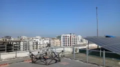 The START radio-telescope antenna array on the rooftop of IUB's academic building, with the city skyline behind.