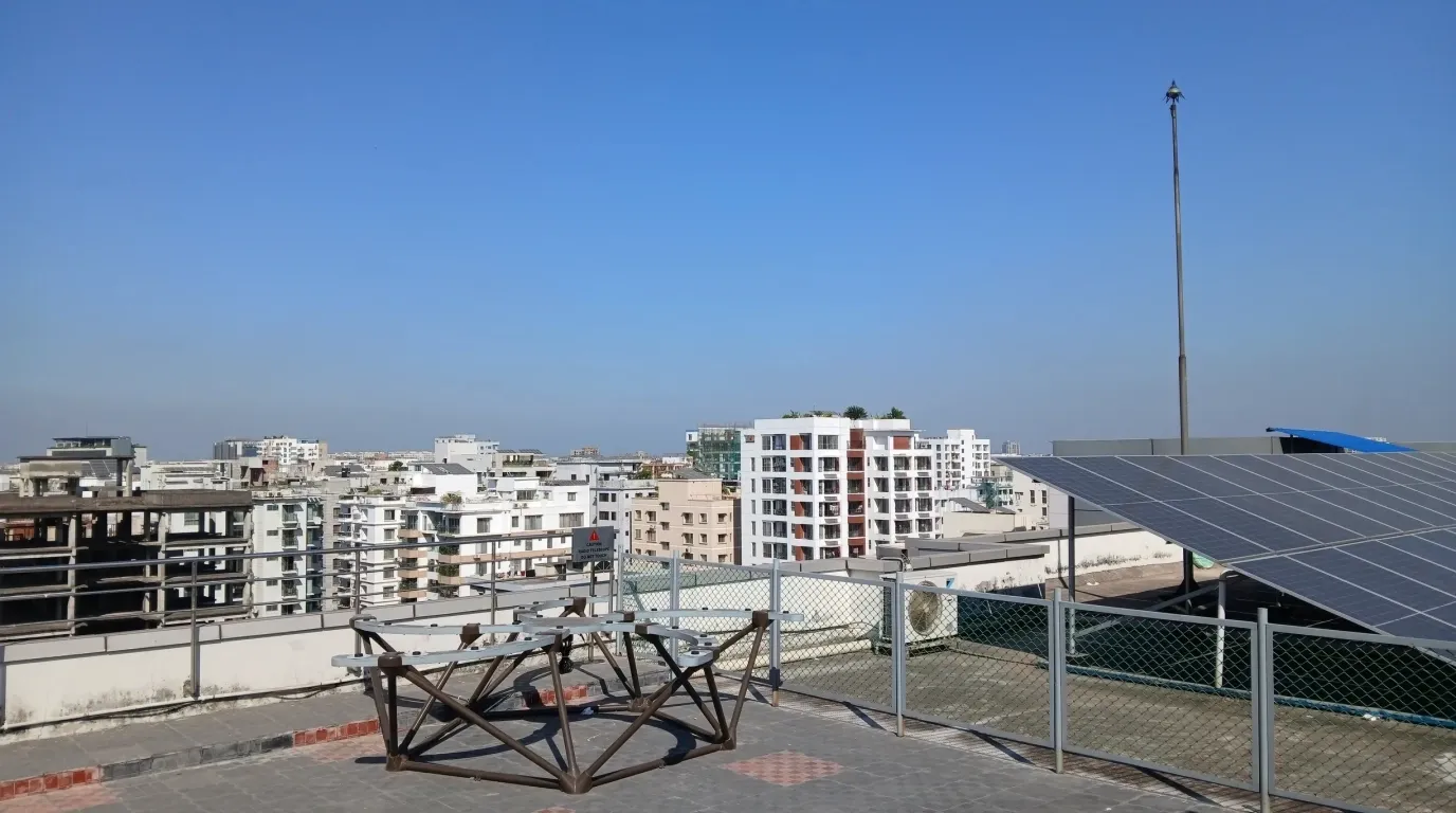 The START radio-telescope antenna array on the rooftop of IUB's academic building, with the city skyline behind.